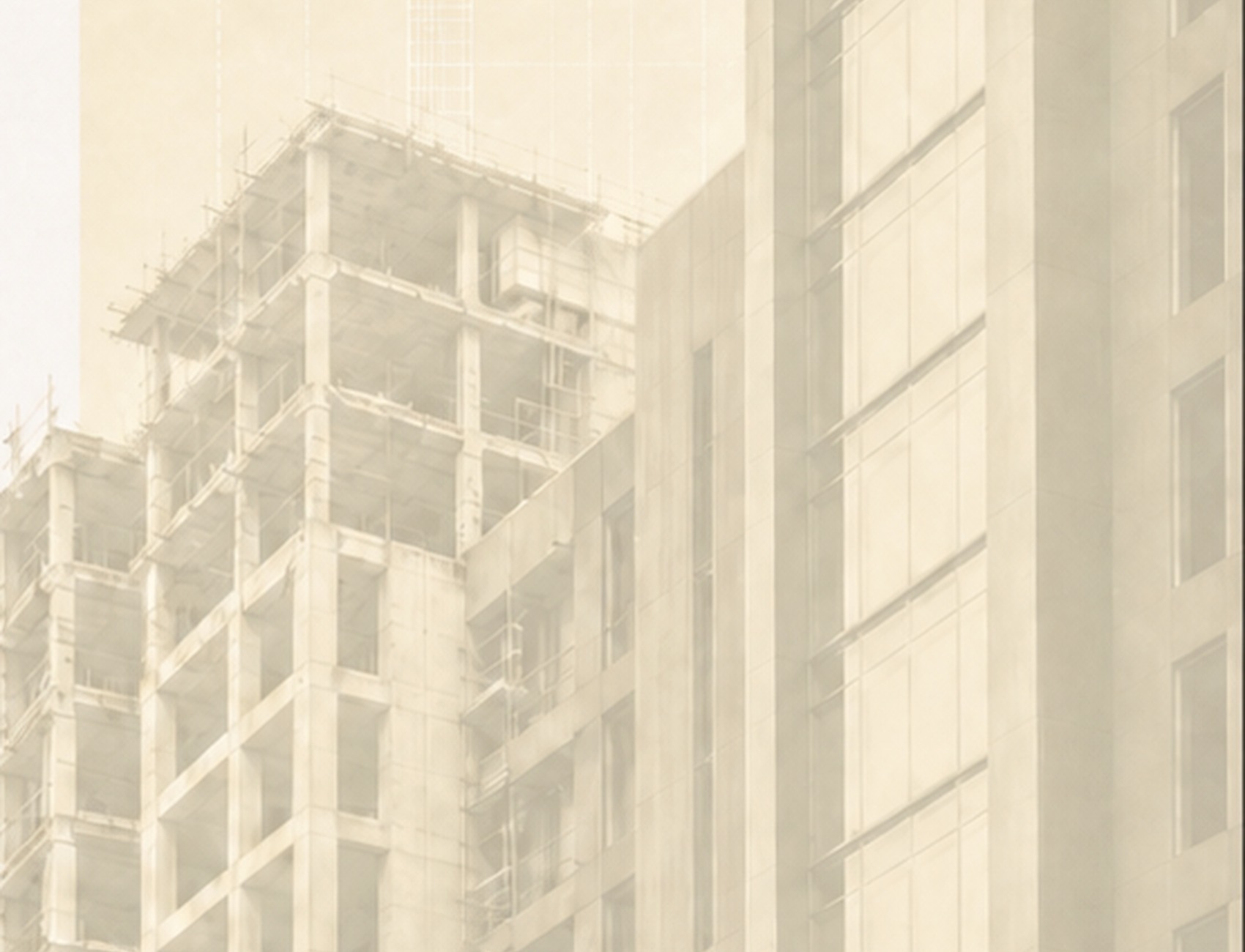 Partially built concrete frame behind a completed modern building facade.